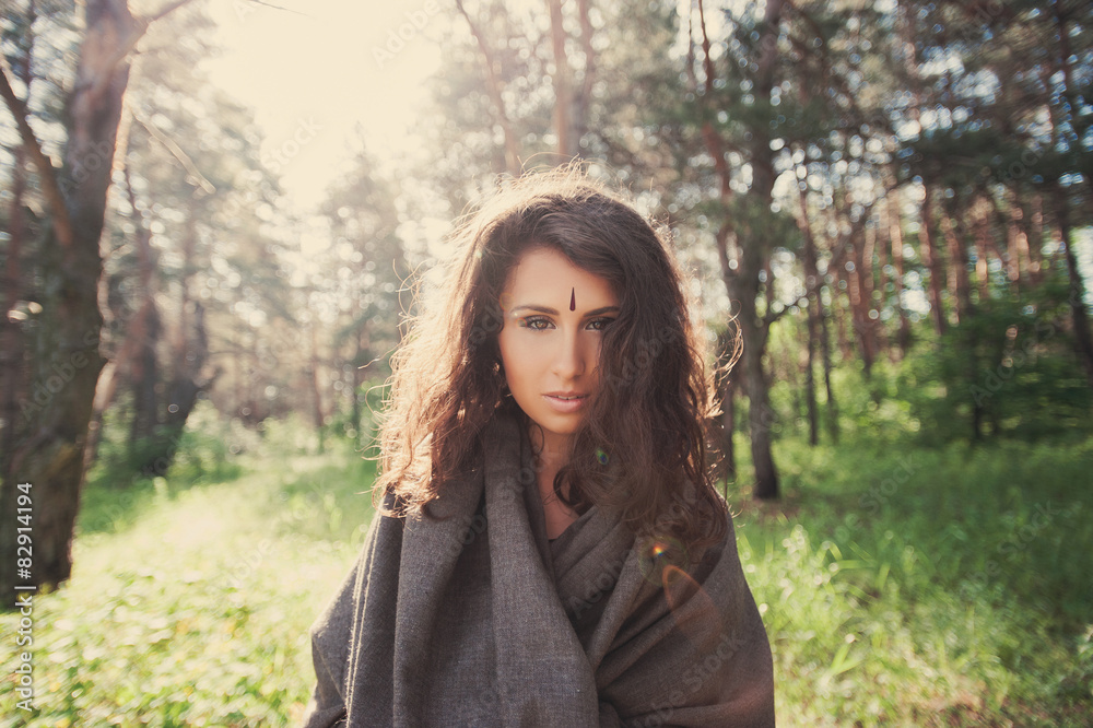 Portrait of a beautiful girl in a gray hooded in the forest Portrait of a beautiful girl in a gray hooded in the forest