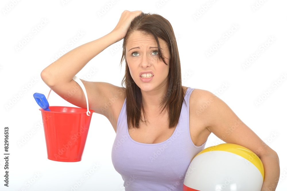 Frustrated Woman on Holiday Holding a Bucket and Beach Ball Frustrated Woman on Holiday Holding a Bucket and Beach Ball