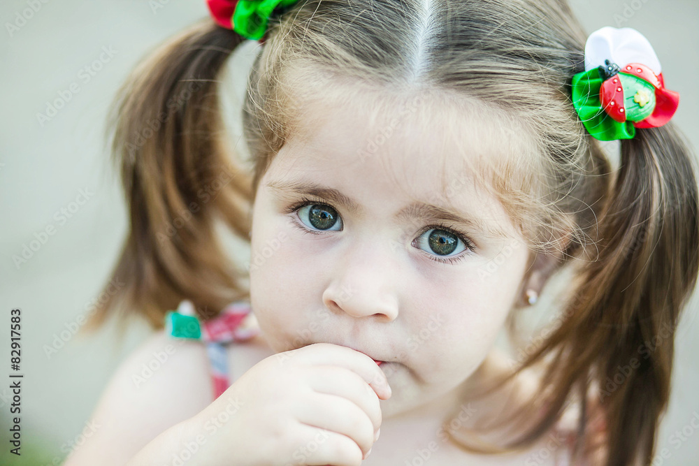 little girl with hair tails looking surprised