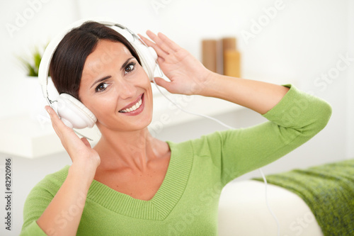 Happy young woman listening to music