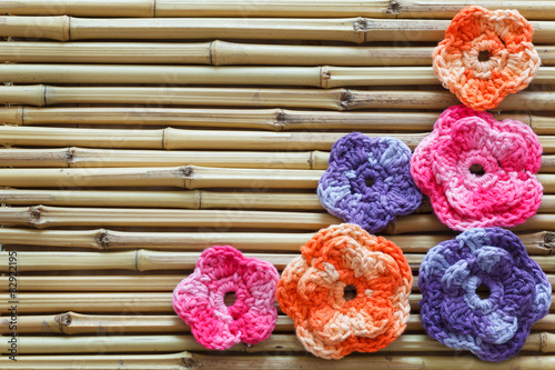 Handmade colorful crochet flowers on bamboo