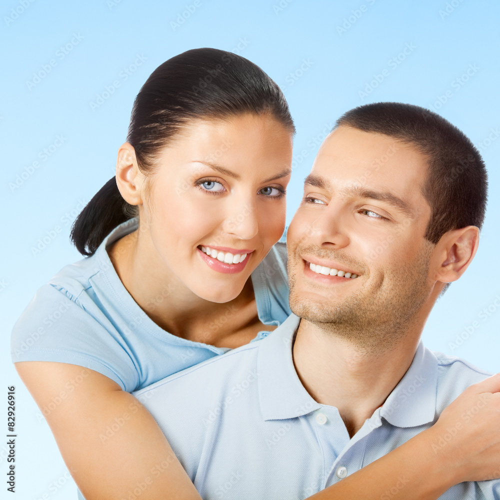 Portrait of smiling attractive couple, over blue sky Portrait of smiling attractive couple, over blue sky