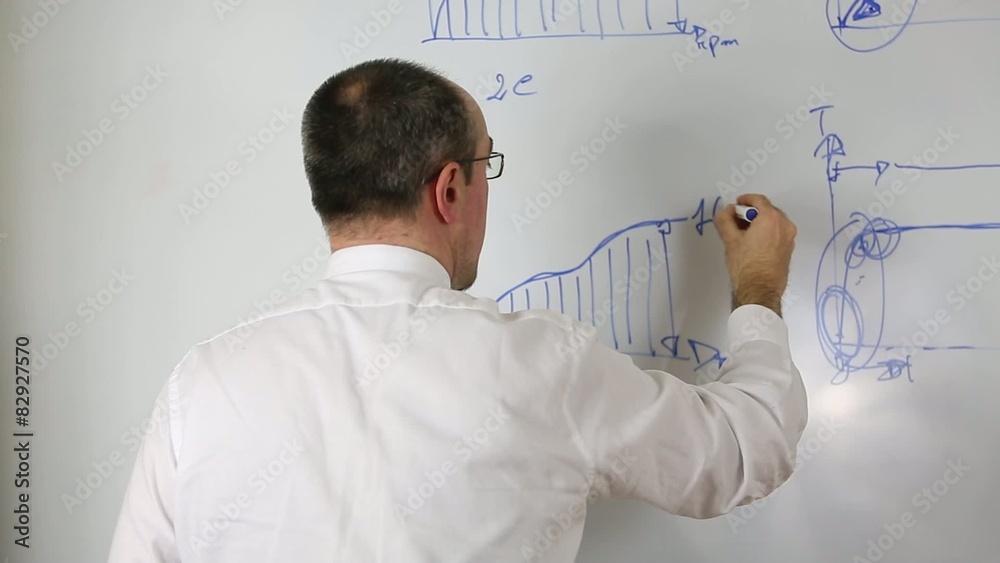 Teacher in suit and tie explaining integrals on whiteboard Teacher in suit and tie explaining integrals on whiteboard