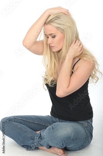 Attractive Young Woman Sitting on the Floor looking Guilty 