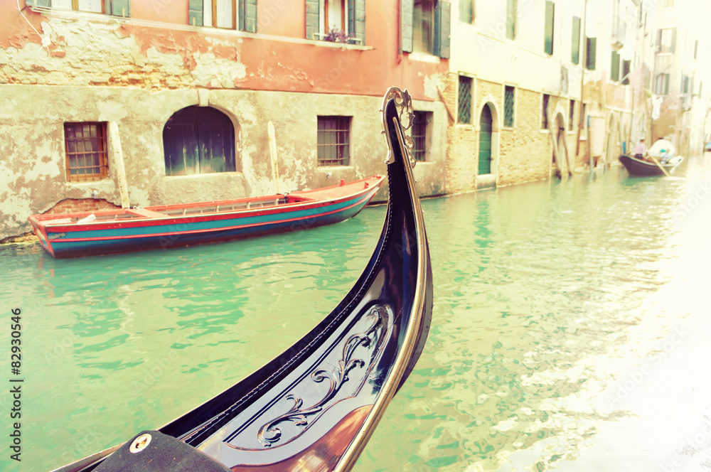 Vintage gondola moored on a venetian canal - Venice, Italy