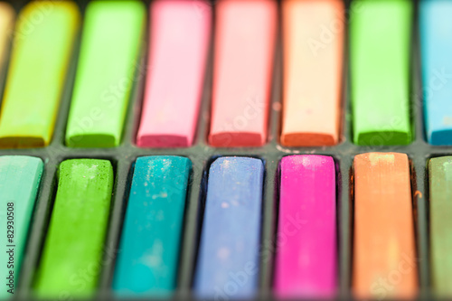 Close up Colorful chalks in a variety of colors arranged in tray