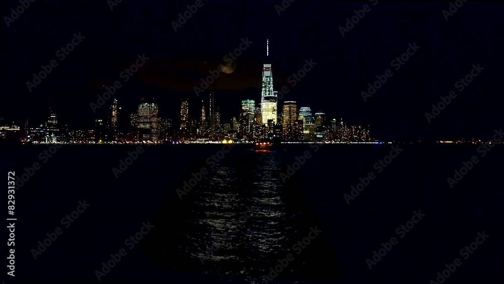 View of Night Manhattan with a full moon from Jersey City.