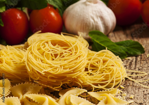 Variety of pasta on a wooden table, selective focus
