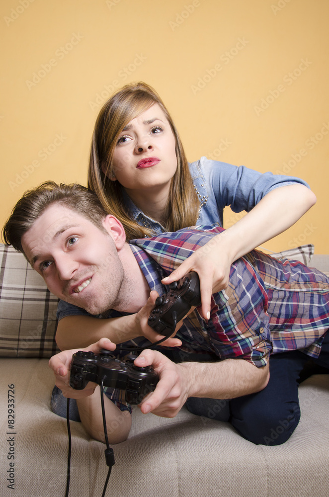 Competitive boyfriend and girlfriend playing video games funny Stock Photo