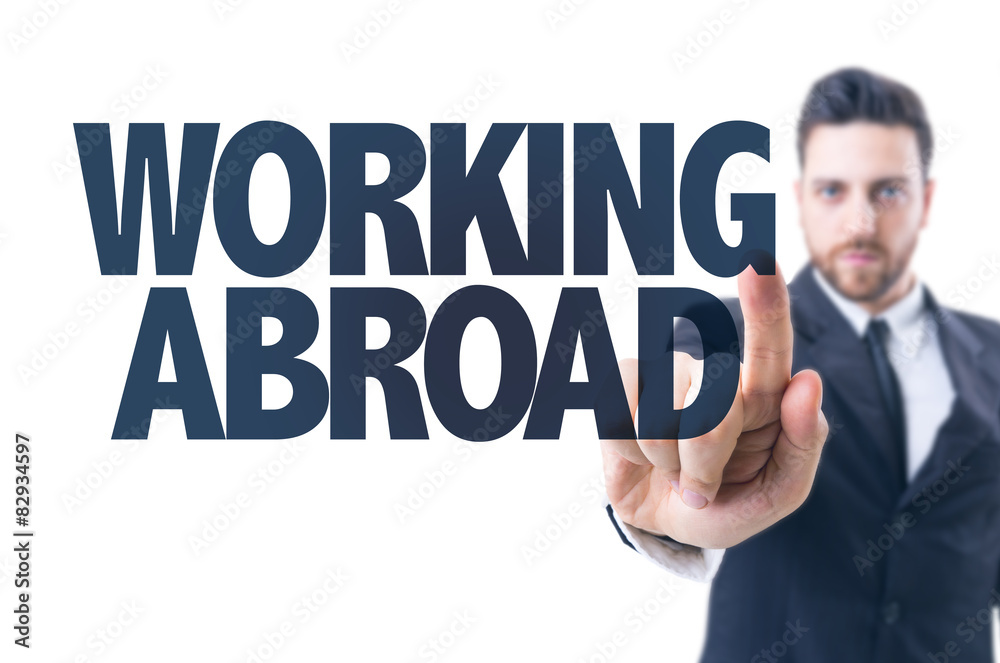 Business man pointing the text: Working Abroad Business man pointing the text: Working Abroad