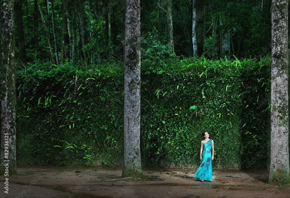 Hispanic woman wearing evening gown in woods Hispanic woman wearing evening gown in woods