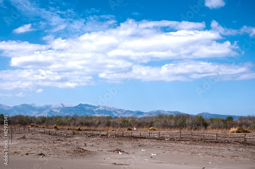 Sandy beach, mountains and blue sky.