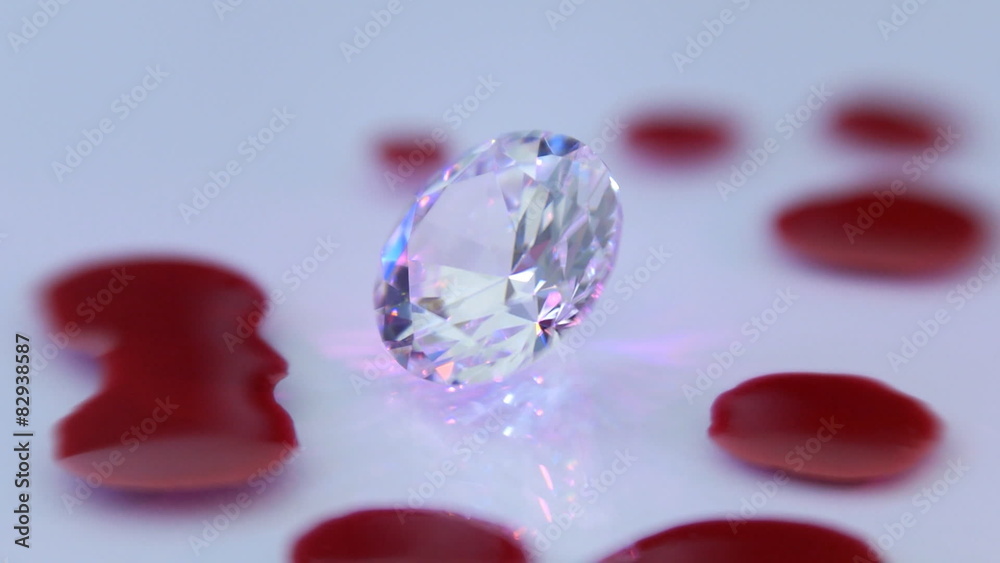 Diamond and drops of blood transfused in colorful rays of light Diamond and drops of blood transfused in colorful rays of light