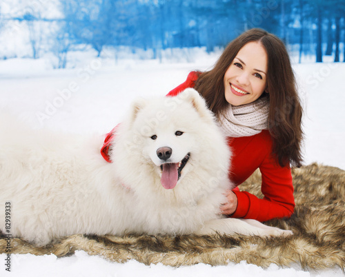 Happy woman owner having fun with white Samoyed dog outdoors in © rohappy