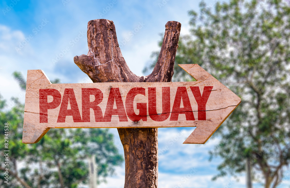 Paraguay wooden sign with countryside background