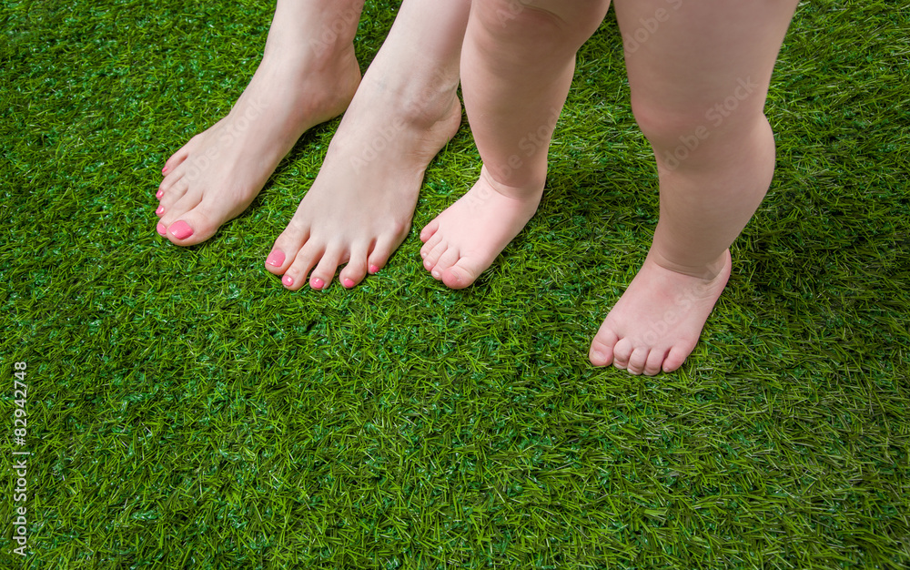  Babyand and Mother legs standing  on grass
