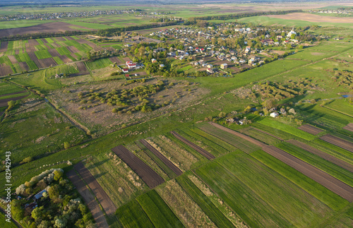 Aerial view of the large green field in spring season