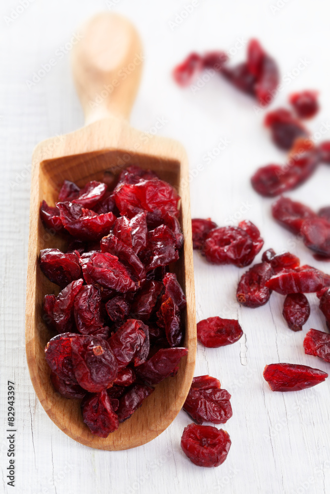 Dry cranberry on white wooden table Dry cranberry on white wooden table
