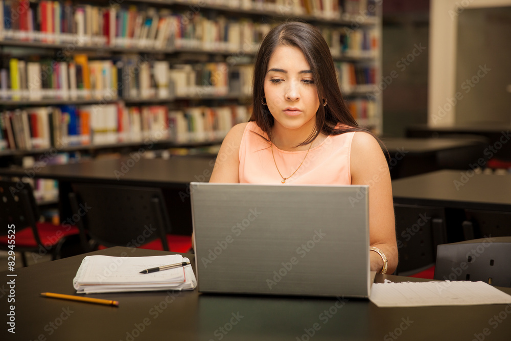 Using a laptop at a library Using a laptop at a library