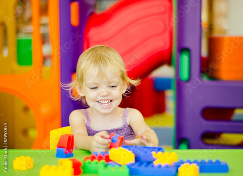 Child  playing with bright plastic construction blocks