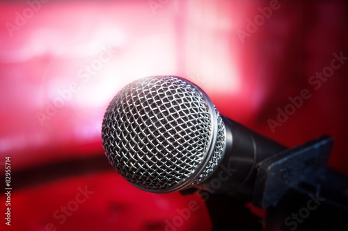 close up texture of microphone in music hall against red luxury