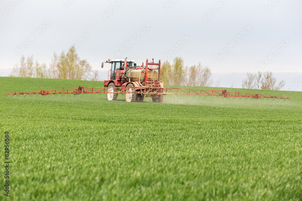 Spraying the herbicides on the green field Spraying the herbicides on the green field