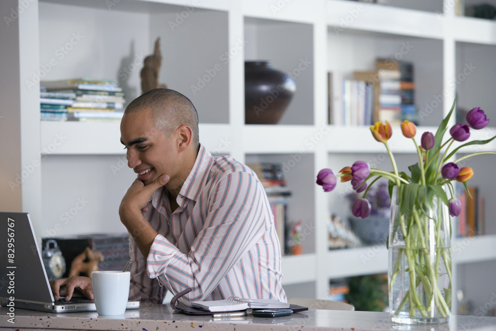 African American man looking at laptop African American man looking at laptop