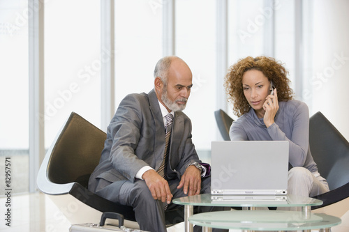 African businesspeople looking at laptop photo