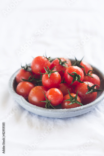 cherry tomatoes on a white surface on a vintage plate