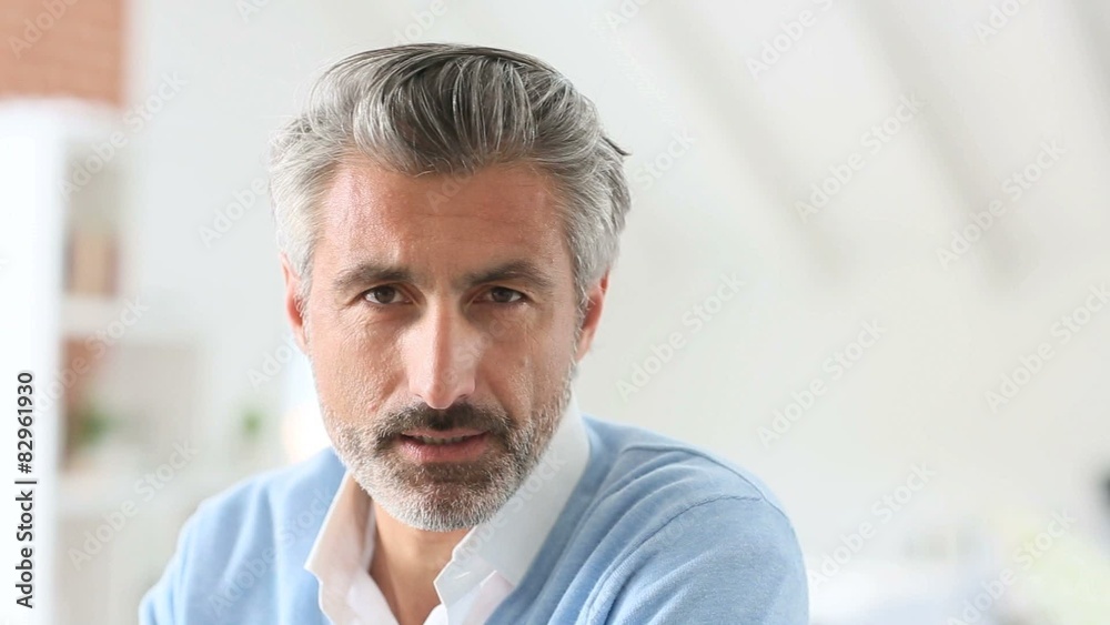 Handsome mature man talking to camera
