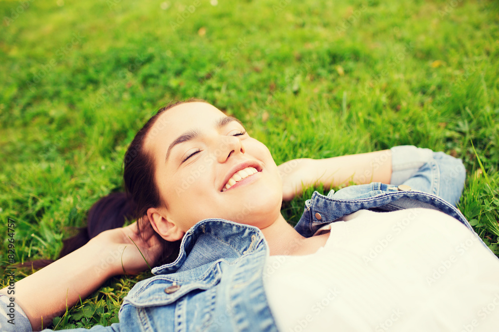 smiling young girl with closed eyes lying on grass smiling young girl with closed eyes lying on grass