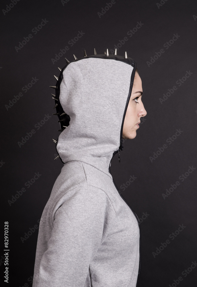 Girl profile portrait wearing hoodie with studs Stock-foto | Adobe Stock