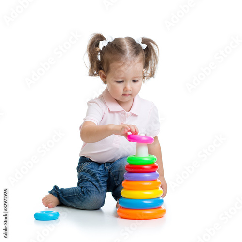 kid toddler playing with pyramid toy