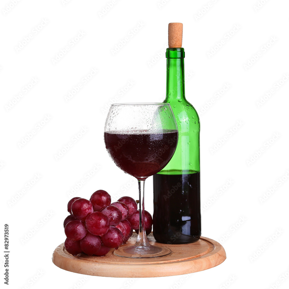 wine glass with red wine, bottle of wine and grapes