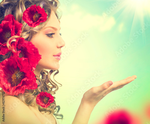 Beauty girl with red poppy flowers hairstyle and open hand