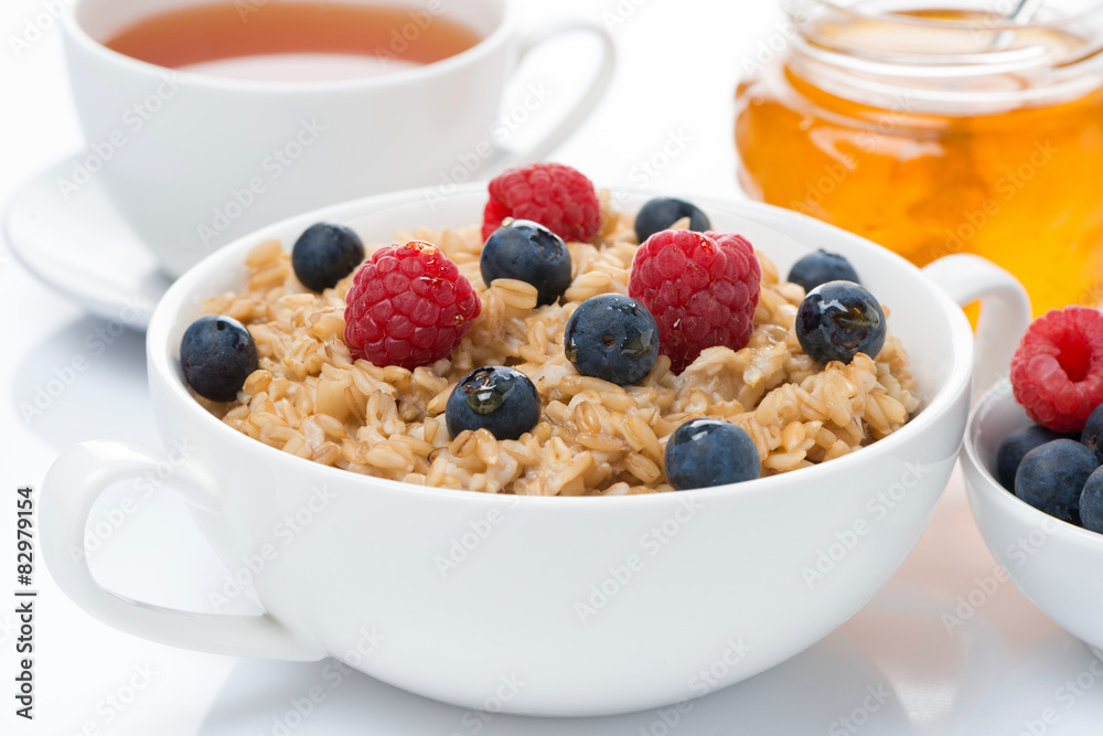 breakfast - oat porridge with fresh berries and honey, black tea breakfast - oat porridge with fresh berries and honey, black tea