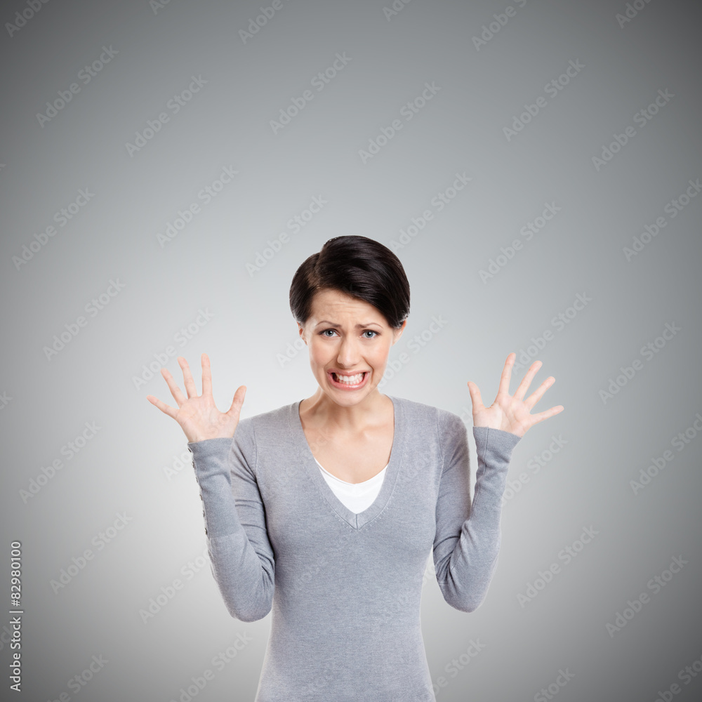 Desperate upset woman, isolated on grey Desperate upset woman, isolated on grey