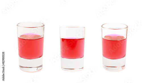 Small glass shot filled with liqueur isolated