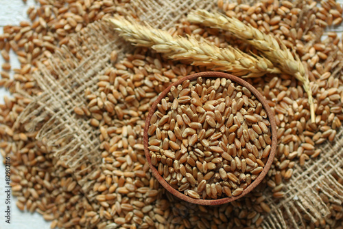 Raw organic spelt on a wooden table