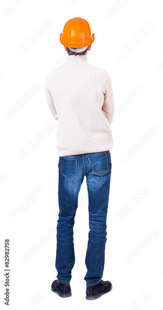 Backview of an engineer in construction helmet stands. Backview of an engineer in construction helmet stands.