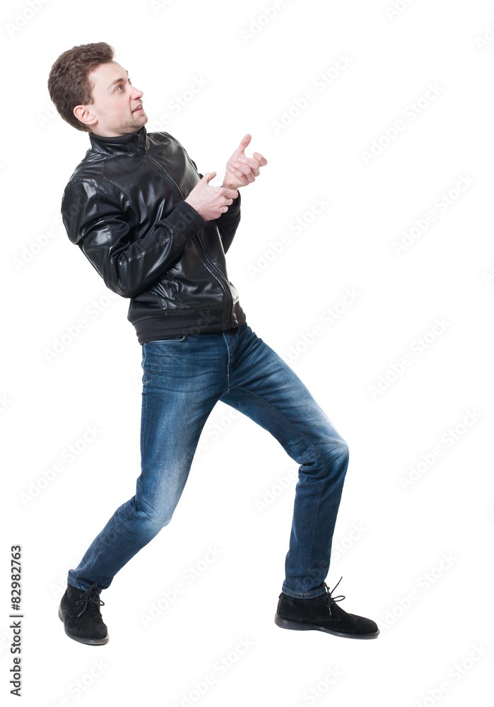 back view of standing man pulling a rope from the top or cling t back view of standing man pulling a rope from the top or cling t