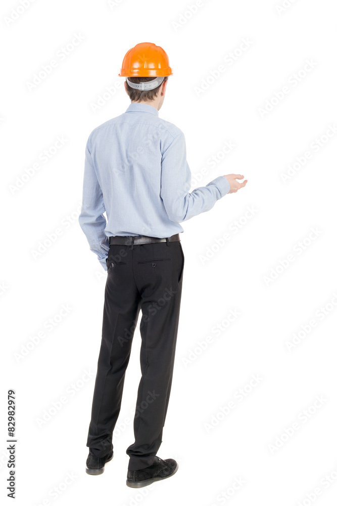 Backview of an engineer in construction helmet stands. Backview of an engineer in construction helmet stands.