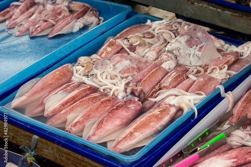 Fresh Squid lay on Tray . cover with Ice.crop frame. Top view sh