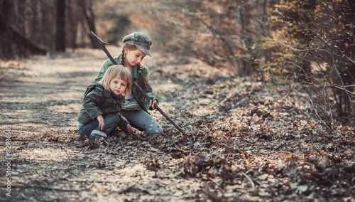 children play in the woods