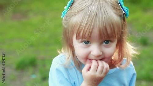 Girl sucking hand on nature