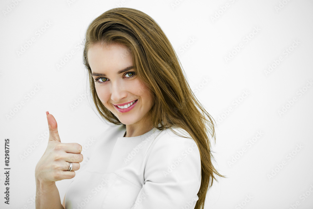 Smiling young beautiful woman in white casual clothing, showing Smiling young beautiful woman in white casual clothing, showing