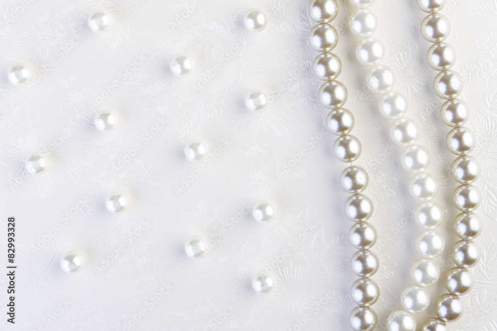White pearls necklace on white paper White pearls necklace on white paper