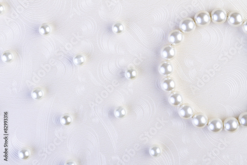 White pearls necklace on white paper
