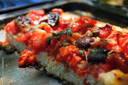 Coseup of a traditional and vegan salad cake pizza