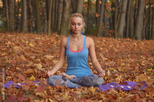Girl, meditating in autumn forest